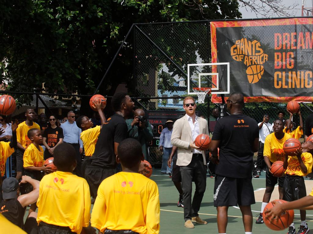 The royal takes part in a basketball exhibition training match at the school. Picture: AFP