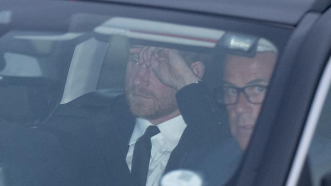 Prince Harry was seen holding his head as he left Aberdeen Airport for Balmoral. Picture: GoffPhotos.com/Australscope