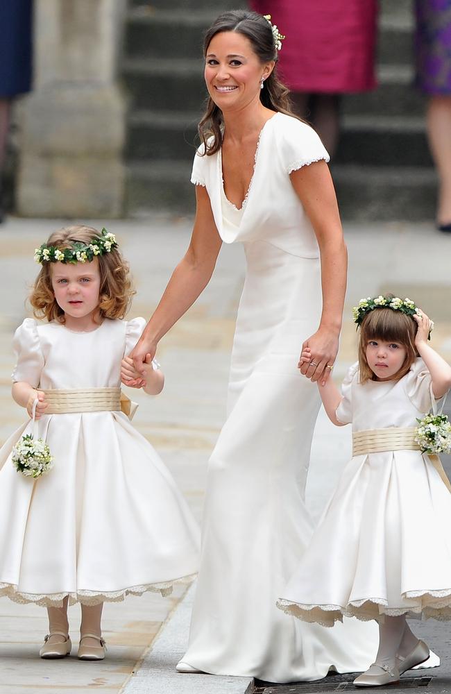 Dress that made her derrière world famous ... Pippa Middleton holds hands with Grace Van Cutsem and Eliza Lopes as they arrive to attend the Royal Wedding of Prince William to Catherine Middleton. Picture: Pascal Le Segretain / Getty Images