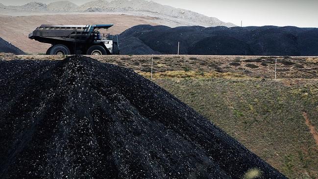 A truck passes a huge pile of coal at the Mt Arthur mine in Muswellbrook. Even the biggest cheerleaders for renewables say coal for energy is on the rise.. Picture: Ian Waldie/Getty Images