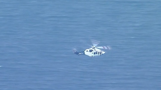 An RACQ Lifeflight helicopter flying Mr Taylor to hospital from the island. Picture: Supplied / Channel 9