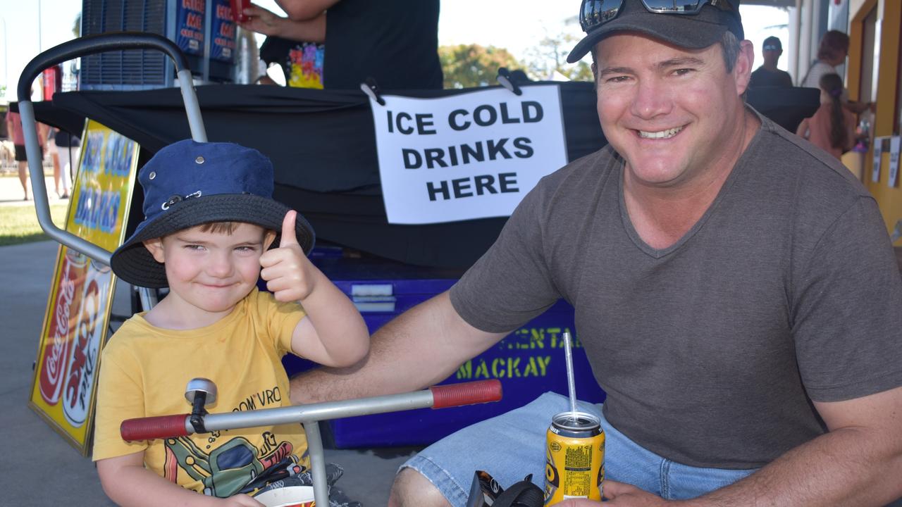 Byron, 3, and Daniel Wade at Big Boys Toys Expo at Mackay Showgrounds 2021. The pair drove in from Moranbah for the expo and Bryon has loved the sideshow alley. Photo: Janessa Ekert and Tara Miko