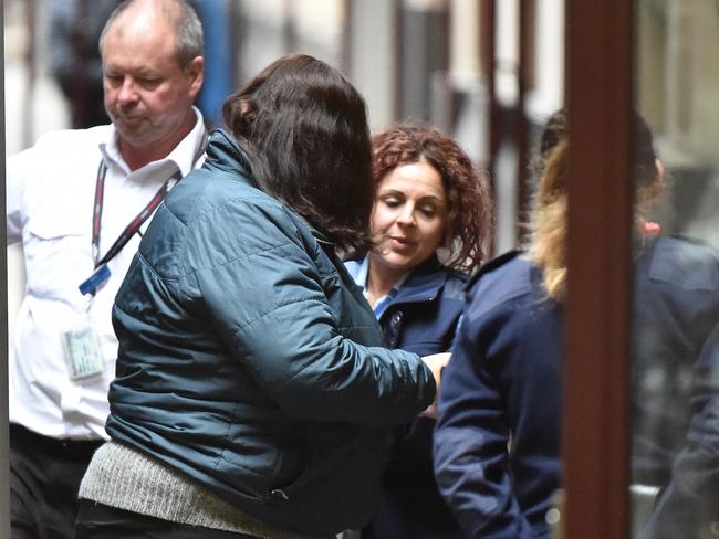 Katia Pyliotis (centre left) arrives at the Supreme Court of Victoria, Melbourne before her sentence was handed down.