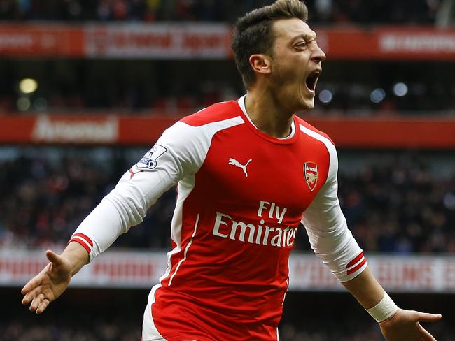 Arsenal's Mesut Ozil celebrates scoring a goal during the English Premier League soccer match between Arsenal and Aston Villa at the Emirates stadium in London, Sunday, Feb. 1, 2015. (AP Photo/Kirsty Wigglesworth)