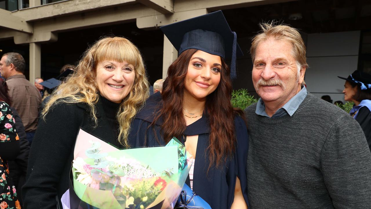 Deakin graduate Meg Laidler with mum Kylie and dad Ian. Picture: Alison Wynd