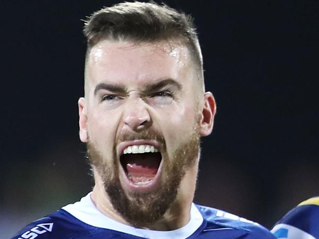 DARWIN, AUSTRALIA - JUNE 29: Clinton Gutherson stretches his mouth as he links arms with Blake Ferguson before kick-of to symbolise solidarity against violence during the round 15 NRL match between the Parramatta Eels and the Canberra Raiders at TIO Stadium on June 29, 2019 in Darwin, Australia. (Photo by Mark Kolbe/Getty Images)