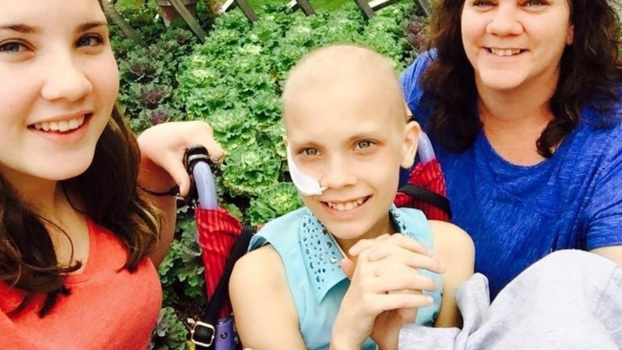 Marnee Millan (centre), during her battle Embryonal Rhabdomyosarcoma when she was 10, pictured with sister Lexie and mum Denise.