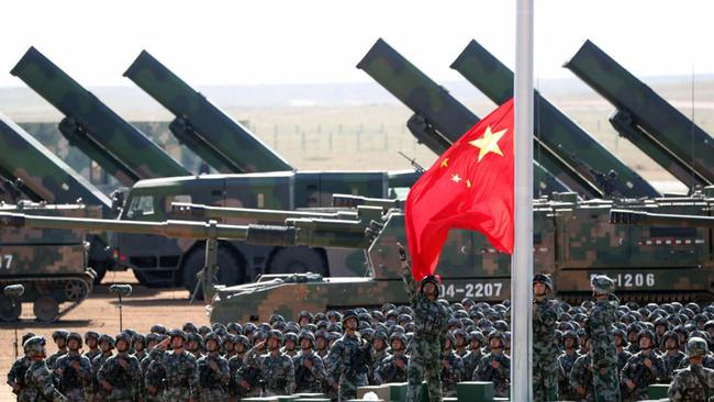 In this photo released by China's Xinhua News Agency, Chinese People's Liberation Army (PLA) troops perform a flag raising ceremony Sunday, July 30, 2017 for a military parade to commemorate the 90th anniversary of the founding of the PLA on Aug. 1 at Zhurihe training base in north China's Inner Mongolia Autonomous Region. (Pang Xinglei/Xinhua via AP)