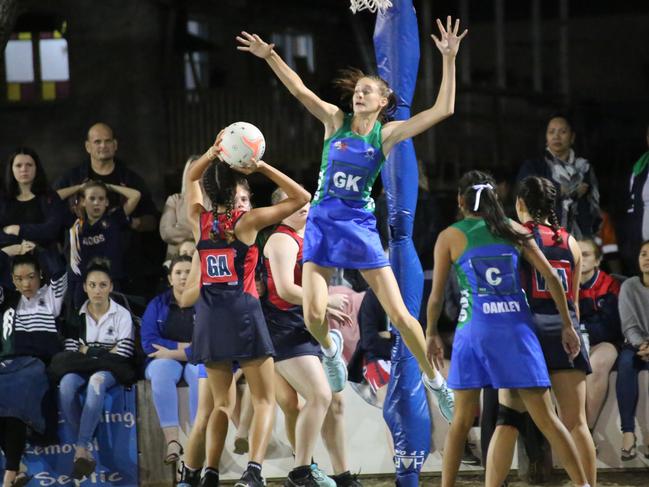 Isabelle Shearer launches into action for The Cathedral College in the Rockhampton and District Secondary Schools Netball competition.