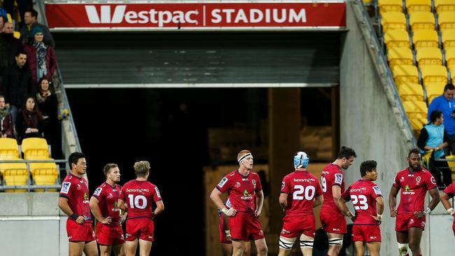 Reds players look on in disappointment after the final Hurricanes try.