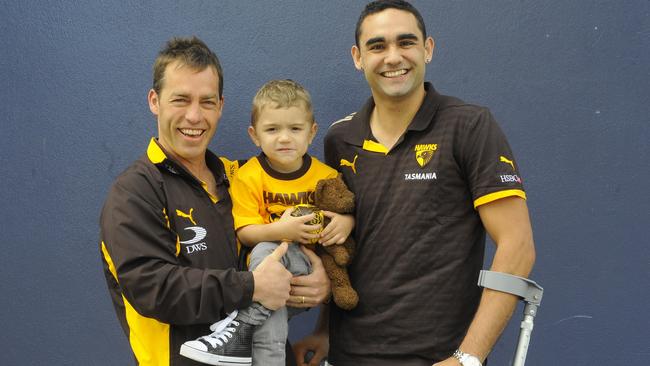 Shaun Burgoyne, on crutches in 2009, with Hawthorn coach Alastair Clarkson and son Ky, then 2. Picture: AAP