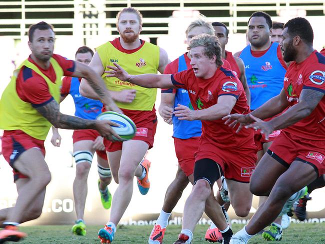 Quade Cooper (left) passes the ball at Queensland training on Monday.