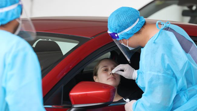 A woman is tested at the Wickham drive-through testing clinic in Newcastle. Picture: David Swift