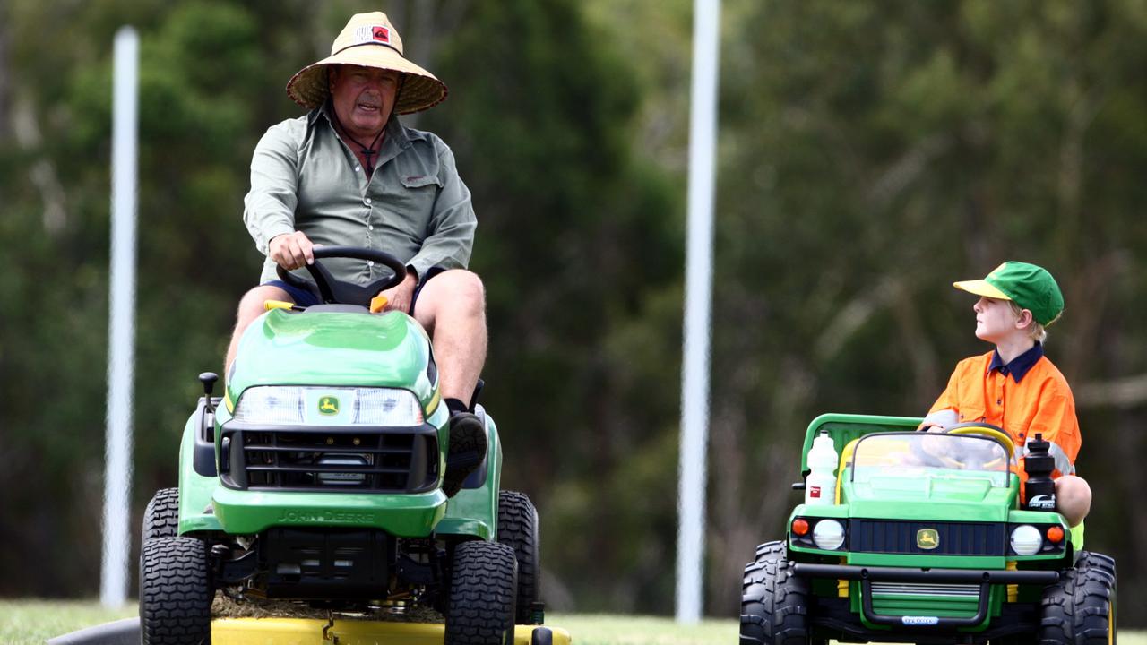 David Moles mowing the field with his son Baxter, 8, in 2012 Picture: Glenn Barnes.