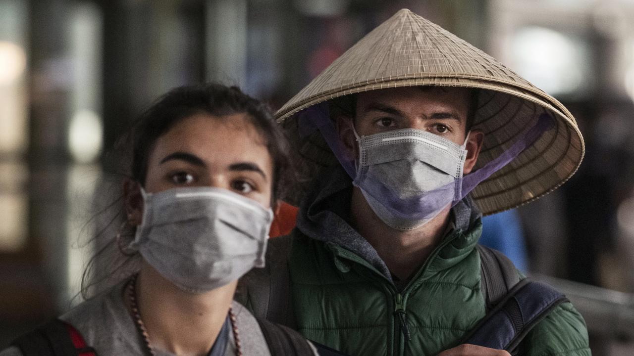 Foreign tourists at Beijing Capital Airport on January 30. Picture: Kevin Frayer/Getty Images)