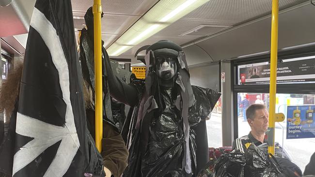 Extinction Rebellion protesters on the tram on the way to the Adelaide Convention Centre. Picture: Todd Lewis