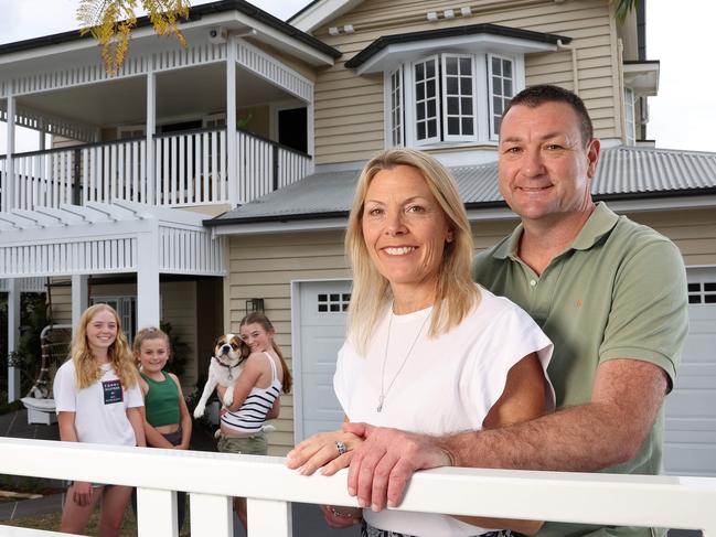 Troy and Sally McMillan with their kids Tayla, 15, Siena, 13, and Bella, 11, at their Kedron home they are selling. Picture: Liam Kidston