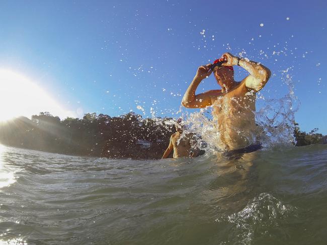 A Portrait of Australia: The best stories from 30 years of Australian Geographic. John Havilah and Robert Virgona (at left) enjoy the early morning surf at Noosa Heads on Queensland's Sunshine Coast. The state's south-east attracts retirees from the rest of the nation for its climate, beaches and more affordable real estate. Photo by Dean Saffron.