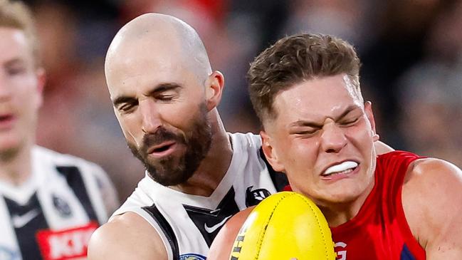 MELBOURNE, AUSTRALIA - AUGUST 23: Taj Woewodin of the Demons is tackled by Steele Sidebottom of the Magpies during the 2024 AFL Round 24 match between the Melbourne Demons and the Collingwood Magpies at The Melbourne Cricket Ground on August 23, 2024 in Melbourne, Australia. (Photo by Dylan Burns/AFL Photos via Getty Images)