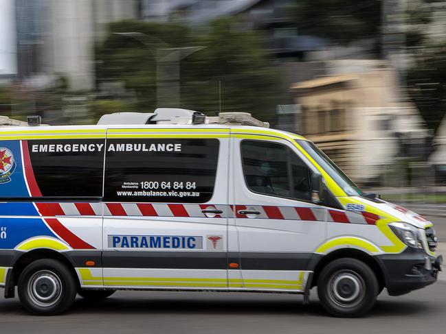 MELBOURNE, AUSTRALIA - NewsWire Photos FEBRUARY 13, 2022: An ambulance speeds away from the Royal Melbourne Hospital. Ambulance, Generic.Picture: NCA NewsWire / David Geraghty