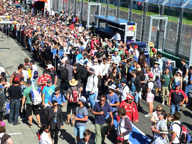 Grand Prix fans walk through pit lane in 2013.