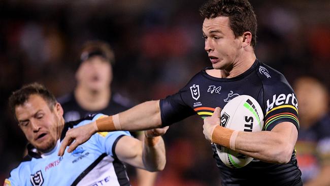 Dylan Edwards fends off a tackle by Josh Morris last season. Pic: AAP/Dan Himbrechts.