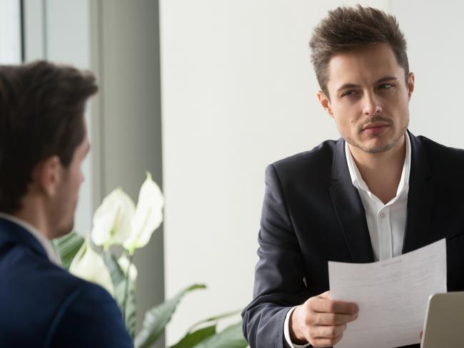 Distrustful businessman holding document at meeting, looking at partner with doubt suspicion, recruiter reads bad resume, caught applicant being dishonest at job interview, shady deal, contract fraud