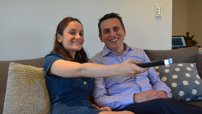 Olivia Matic, 17, with her father Councillor Peter Matic on the couch at home with the TV remote. Cr Matic said he was very upset at the backlash to a rare chance to spend time with his daughter watching the Bachelorette.