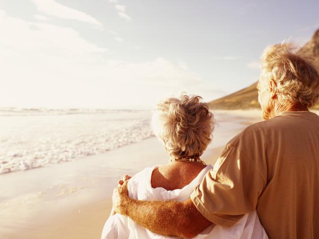 Senior couple embracing on beach, rear viewretirees thinkstockolder couple walking on the beachsuperannuation genericelderly, active, wealth, couple, aging, beach, cancer