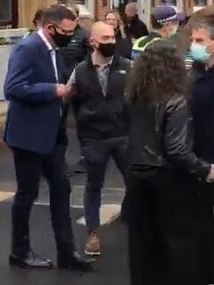 Premier Daniel Andrews is mobbed by protesters in Bendigo.