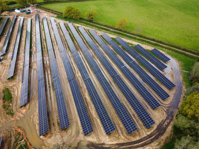 TOPSHOT - An aerial view of a solar farm nearing completion in Heckfield near Hook, Hampshire on April 23, 2023. The solar farm is on target for completion in 2024 and is estimated to provide power to more than 6000 homes. It will have 33,102 bifacial solar panels, generating more than 19,000 MWhs of energy per annum. (Photo by Adrian DENNIS / AFP)