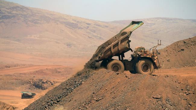 An autonomous haul truck dumps a load of rock in the mine pit at Rio Tinto Group's Gudai-Darri iron ore mine, which relies heavily on the China market. Picture: Carla Gottgens/Bloomberg