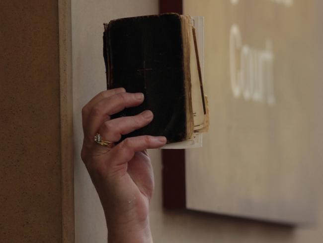 A bible is held up for the media outside Melbourne Magistrates’ Court. Picture: AAP Image/Stefan Postles