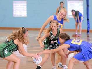 TIGHT TUSSLE: Action between Grafton High (blue) and Tweed River High in the CHS North Coast under-15 Netball final at Grafton Sports Centre. PHOTOS: ADAM HOURIGAN