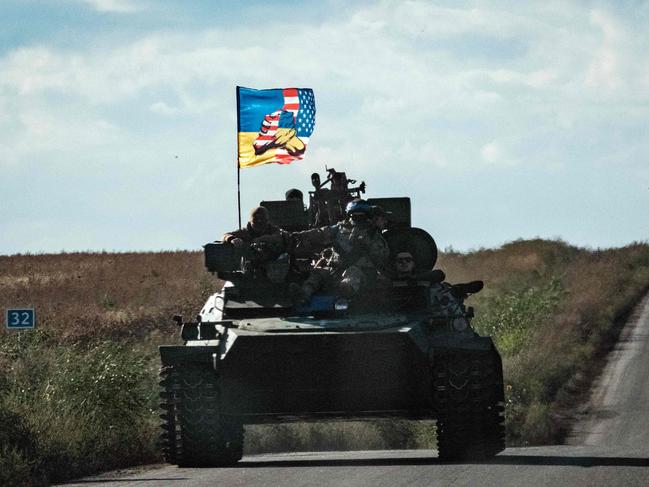 A Ukrainian tank rides with a flag picturing Ukraine and US flags shaking hands in Novostepanivka, Kharkiv region, on September 19, 2022, amid the Russian invasion of Ukraine. Picture: Yasuyoshi CHIBA / AFP