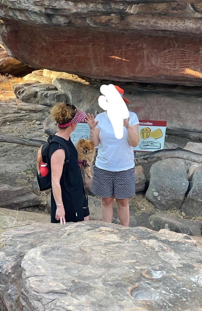 A Reddit user shared a de-identified image of two people walking through what appears to be Kakadu National Park. Dogs – excluding guide, hearing, and assistance dogs – are prohibited from Commonwealth national parks.