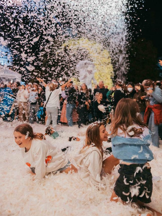 Young WOMADelaide festivalgoers playing in the feathers during a performance of Place des Anges on Friday. Picture: Wade Whitington