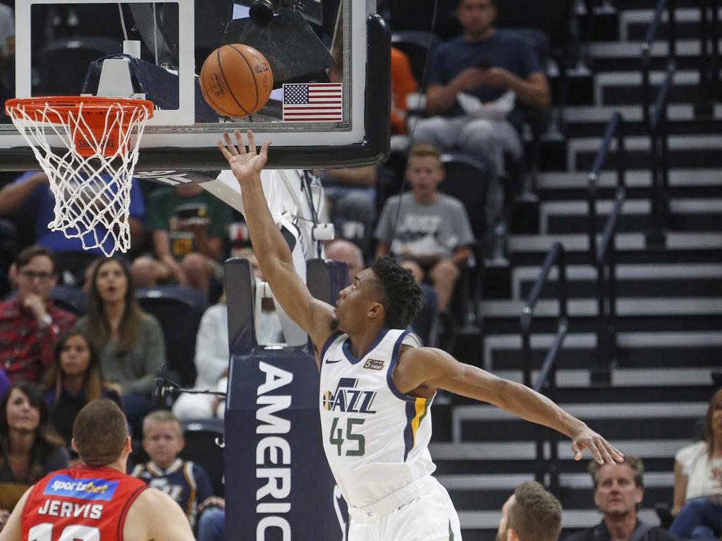 Utah Jazz guard Donovan Mitchell goes to the basket against the Wildcats.