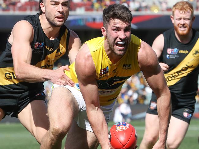 SANFL GRAND FINAL - Sunday, 3rd October, 2021. Glenelg v Eagles at The Adelaide Oval. Rory Lehmann of the Eagles handless the ball away from Brett Turner of Glenelg Picture: Sarah Reed