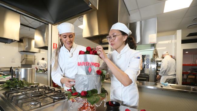 Charlotte Young and Bujin Chuluunbaatar put the finishing touches to a cake. Picture: Richard Gosling.