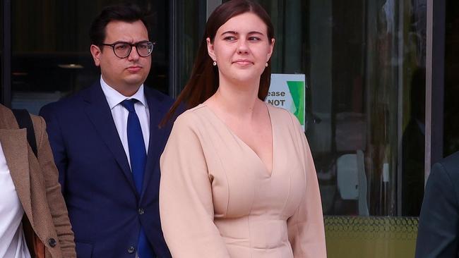 Brittany Higgins leaves the ACT Magistrates Court with members of her legal team in Canberra.