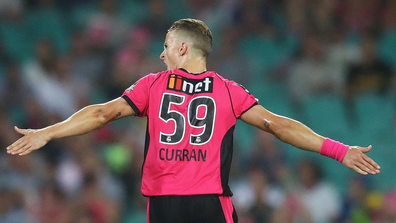 Tom Curran steams away to celebrate a wicket for Sydney Sixers.