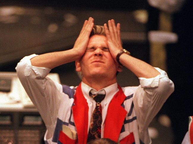 Trader Chris Chapel with head in his hands agonises as stocks plummet at Sydney Stock Exchange 28 Oct 1997. market crash traders