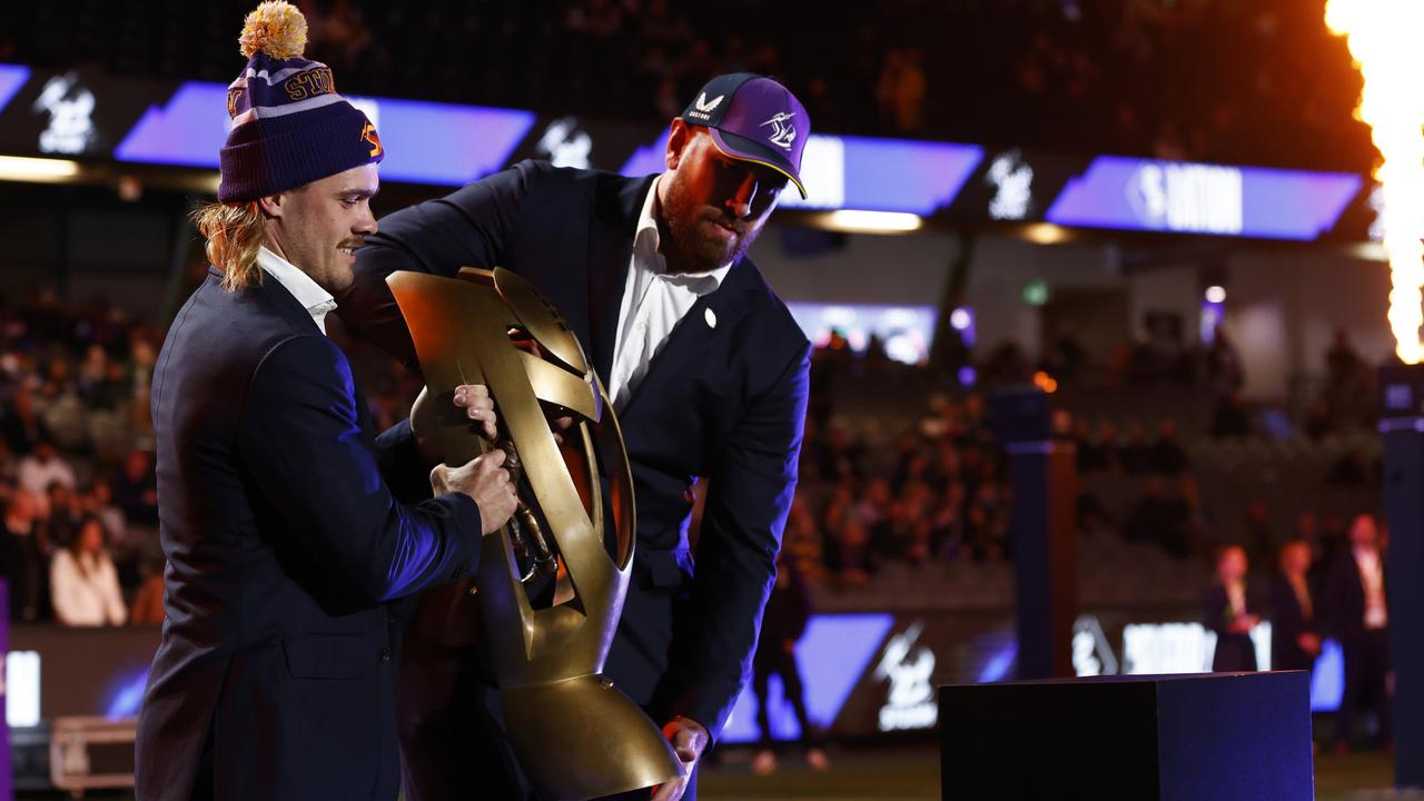 Ryan Papenhuyzen (L) and Nelson Asofa-Solomona of the Storm carry the 2020 NRL Premiership Trophy. (Photo by Daniel Pockett/Getty Images)