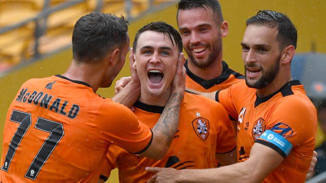 Dylan Wenzel-Halls (centre) of the Roar celebrates scoring a goal with Scott McDonald (left) and Jack Hingert (right) during the Round 15 A-League match between Brisbane Roar FC and Wellington Phoenix at Suncorp Stadium in Brisbane, Saturday, January 18, 2020. (AAP Image/Darren England) NO ARCHIVING, EDITORIAL USE ONLY