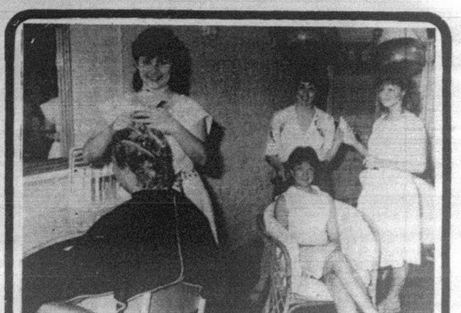 Old photographs of Michelle Stewart in the newspaper at her William St hair salon. Picture: FILE