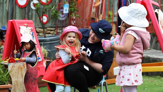 Childcare worker Gemma Miller paints with Bailey, 3, at Top Ryde Early Learning centre in Sydney. Picture: Jane Dempster