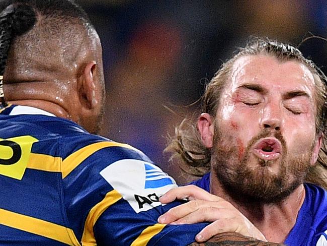 Kieran Foran of the Bulldogs is tackled by Junior Paulo of the Eels during the Round 23 NRL match between the Parramatta Eels and the Canterbury-Bankstown Bulldogs at Bankwest Stadium in Sydney, Thursday, August 22, 2019. (AAP Image/Dan Himbrechts) NO ARCHIVING, EDITORIAL USE ONLY