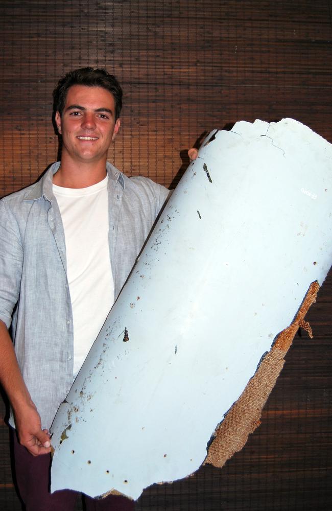 Liam Lotter poses with debris thought to have come from MH370. Malaysian officials are expected to escort the piece to KL, where it will be locked in a room at the Ministry of Transport with Mr Gibson’s piece for ‘safekeeping’.