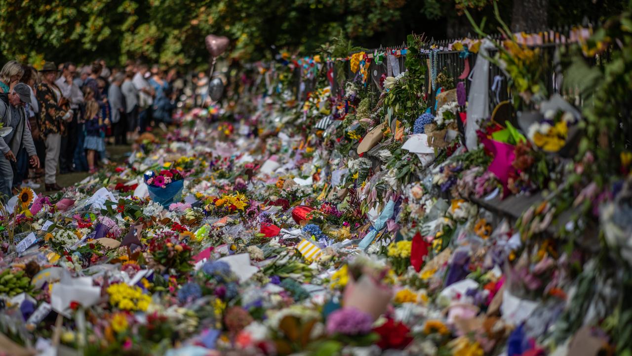 People view flowers and tributes by the botanical gardens in Christchurch. Picture: Carl Court/Getty Images